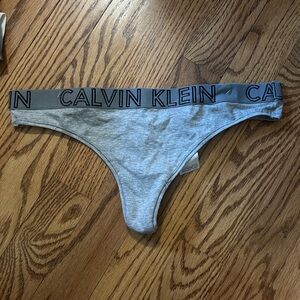 NWOT Calvin Klein grey and black thong